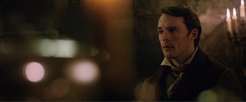 Movie still from “My Cousin Rachel” (2017), directed by Roger Michell – A man in a suit and tie looking to his left; Close Up shot, Over the shoulder angle