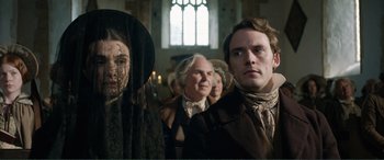 Movie still from “My Cousin Rachel” (2017), directed by Roger Michell – A group of people standing next to each other in front of a window; Close Up shot, Over the shoulder angle