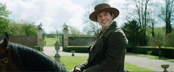 Movie still from “My Cousin Rachel” (2017), directed by Roger Michell – A man in a hat is riding on a horse; Medium shot, Over the shoulder angle