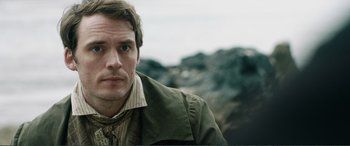 Movie still from “My Cousin Rachel” (2017), directed by Roger Michell – A person wearing a jacket; Close Up shot, Over the shoulder angle