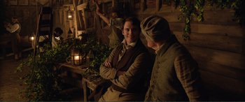 Movie still from “My Cousin Rachel” (2017), directed by Roger Michell – A man sitting next to another man in a room; Medium shot, Over the shoulder angle