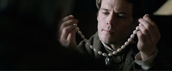 Movie still from “My Cousin Rachel” (2017), directed by Roger Michell – A man holding a string of pearls in his hand; Close Up shot, Over the shoulder angle