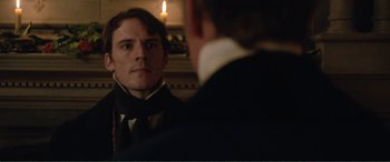 Movie still from “My Cousin Rachel” (2017), directed by Roger Michell – A man looking at himself in the mirror in front of another man; Close Up shot, Over the shoulder angle