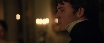 Movie still from “My Cousin Rachel” (2017), directed by Roger Michell – A person wearing a suit and tie; Close Up shot, Over the shoulder angle