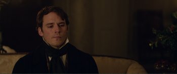Movie still from “My Cousin Rachel” (2017), directed by Roger Michell – A man wearing a suit and tie sitting in a chair; Close Up shot, Over the shoulder angle