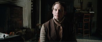 Movie still from “My Cousin Rachel” (2017), directed by Roger Michell – A man wearing a suit and a neck tie; Close Up shot, Over the shoulder angle