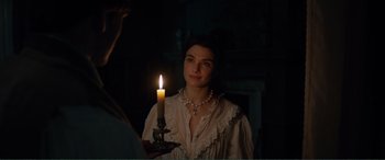 Movie still from “My Cousin Rachel” (2017), directed by Roger Michell – A woman holding a lit candle in a dark room; Close Up shot, Over the shoulder angle