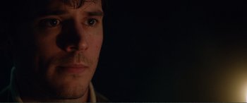 Movie still from “My Cousin Rachel” (2017), directed by Roger Michell – A person's face with a dark background; Extreme Close Up shot, Over the shoulder angle