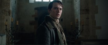 Movie still from “My Cousin Rachel” (2017), directed by Roger Michell – A man wearing a leather jacket standing in a room; Close Up shot, Over the shoulder angle