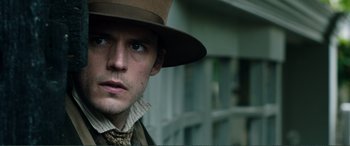 Movie still from “My Cousin Rachel” (2017), directed by Roger Michell – A person wearing a hat; Close Up shot, Over the shoulder angle