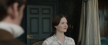 Movie still from “My Cousin Rachel” (2017), directed by Roger Michell – A woman sitting in front of a green door; Close Up shot, Over the shoulder angle