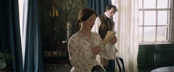 Movie still from “My Cousin Rachel” (2017), directed by Roger Michell – A woman standing next to a man holding papers; Medium shot, Over the shoulder angle