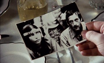 Movie still from “My Dinner with Andre” (1981), directed by Louis Malle – An old photo of a man and a woman; Extreme Close Up shot, High angle