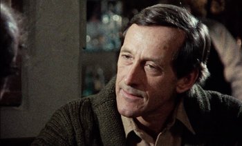 Movie still from “My Dinner with Andre” (1981), directed by Louis Malle – A person sitting in a room; Close Up shot, Over the shoulder angle