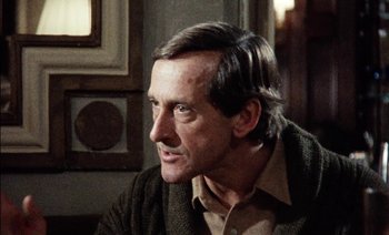 Movie still from “My Dinner with Andre” (1981), directed by Louis Malle – A person sitting in a room; Close Up shot, Over the shoulder angle