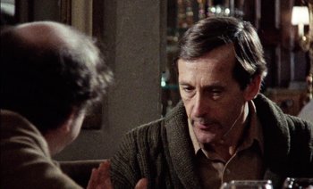 Movie still from “My Dinner with Andre” (1981), directed by Louis Malle – An older man wearing headphones talking to a younger man; Close Up shot, Over the shoulder angle