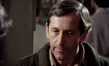 Movie still from “My Dinner with Andre” (1981), directed by Louis Malle – A person wearing a sweater; Close Up shot, Over the shoulder angle