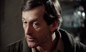 Movie still from “My Dinner with Andre” (1981), directed by Louis Malle – A person wearing a sweater; Close Up shot, Over the shoulder angle