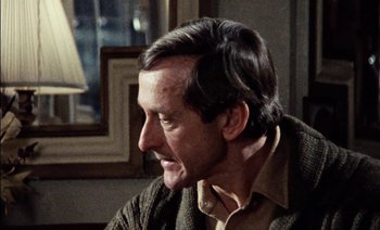 Movie still from “My Dinner with Andre” (1981), directed by Louis Malle – A person sitting in a room; Close Up shot, Over the shoulder angle