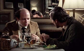 Movie still from “My Dinner with Andre” (1981), directed by Louis Malle – Two men sitting at a table with a plate of food; Medium shot, Over the shoulder angle