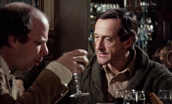 Movie still from “My Dinner with Andre” (1981), directed by Louis Malle – Two men sitting at a table in front of wine glasses; Close Up shot, Over the shoulder angle