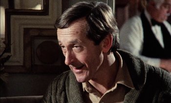 Movie still from “My Dinner with Andre” (1981), directed by Louis Malle – A person wearing a sweater; Close Up shot, Over the shoulder angle