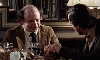 Movie still from “My Dinner with Andre” (1981), directed by Louis Malle – Two people sitting at a table with a glass of red wine; Close Up shot, Over the shoulder angle