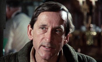 Movie still from “My Dinner with Andre” (1981), directed by Louis Malle – A person wearing a sweater; Close Up shot, Low angle