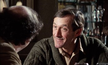 Movie still from “My Dinner with Andre” (1981), directed by Louis Malle – A person sitting at a table; Close Up shot, Over the shoulder angle