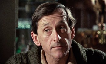 Movie still from “My Dinner with Andre” (1981), directed by Louis Malle – A person wearing a sweater; Close Up shot, Low angle
