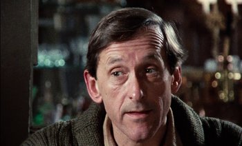 Movie still from “My Dinner with Andre” (1981), directed by Louis Malle – A person wearing a sweater; Close Up shot, Low angle