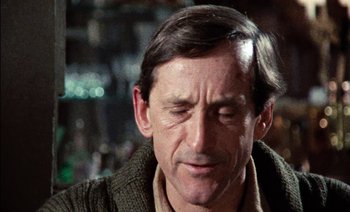 Movie still from “My Dinner with Andre” (1981), directed by Louis Malle – A person with his eyes closed; Close Up shot, Over the shoulder angle