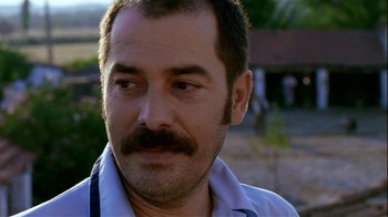Movie still from “My Father and My Son” (2005), directed by Çagan Irmak – A person with a mustache; Close Up shot, Over the shoulder angle