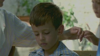 Movie still from “My Father and My Son” (2005), directed by Çagan Irmak – A young boy with his head in his hands; Close Up shot, Over the shoulder angle