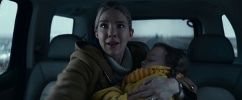 Movie still from “Fractured” (2019), directed by Brad Anderson – A woman holding a baby in the back of a car; Close Up shot, Low angle