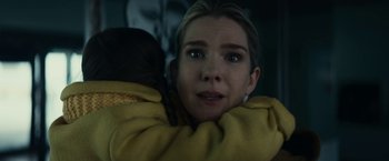 Movie still from “Fractured” (2019), directed by Brad Anderson – A young woman is holding a blanket over her shoulder; Close Up shot, Low angle