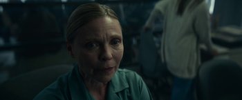 Movie still from “Fractured” (2019), directed by Brad Anderson – A person wearing a green shirt; Close Up shot, Over the shoulder angle