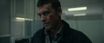 Movie still from “Fractured” (2019), directed by Brad Anderson – A person wearing a shirt and jacket; Close Up shot, Over the shoulder angle