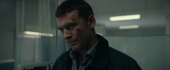 Movie still from “Fractured” (2019), directed by Brad Anderson – A person wearing a shirt and jacket; Close Up shot, Over the shoulder angle