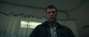 Movie still from “Fractured” (2019), directed by Brad Anderson – A person wearing a shirt and jacket; Close Up shot, Low angle