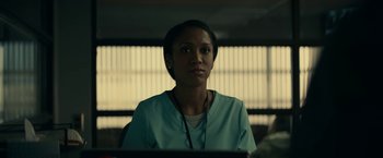 Movie still from “Fractured” (2019), directed by Brad Anderson – A woman wearing a white shirt and a blue shirt; Close Up shot, Low angle