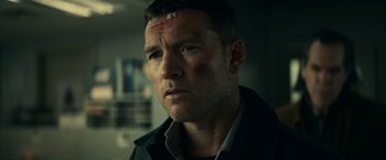 Movie still from “Fractured” (2019), directed by Brad Anderson – A person wearing a shirt and jacket; Close Up shot, Low angle