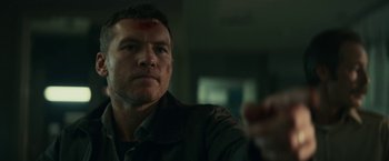 Movie still from “Fractured” (2019), directed by Brad Anderson – A person holding a gun; Close Up shot, Over the shoulder angle