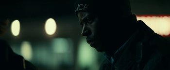 Movie still from “Fractured” (2019), directed by Brad Anderson – A person wearing a hat; Close Up shot, Over the shoulder angle