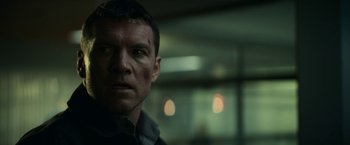 Movie still from “Fractured” (2019), directed by Brad Anderson – A person wearing a black jacket; Close Up shot, Low angle