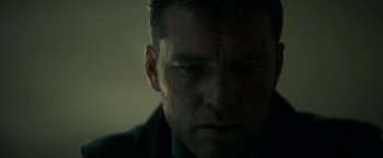 Movie still from “Fractured” (2019), directed by Brad Anderson – A person looking down at his face; Close Up shot, Low angle