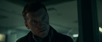 Movie still from “Fractured” (2019), directed by Brad Anderson – A person wearing a suit and tie; Close Up shot, Low angle