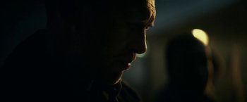 Movie still from “Fractured” (2019), directed by Brad Anderson – A man's face in the dark; Extreme Close Up shot, Over the shoulder angle