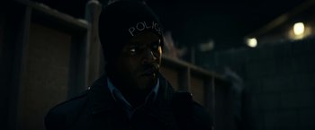 Movie still from “Fractured” (2019), directed by Brad Anderson – A man with a police hat on looking into the distance; Close Up shot, Over the shoulder angle