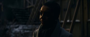 Movie still from “Fractured” (2019), directed by Brad Anderson – A woman in a gray coat is looking at the camera; Close Up shot, Over the shoulder angle